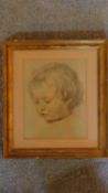 A glazed and framed pencil drawing and highlighted portrait of a young child, signed. 37x33cm