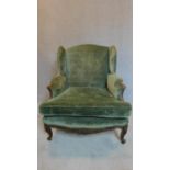 A 19th century carved beechwood French fauteuil in green upholstery. H.90 W.90 D.70cm