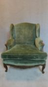 A 19th century carved beechwood French fauteuil in green upholstery. H.90 W.90 D.70cm