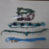A collection of five necklaces, to include a fluorite necklace, a turquoise necklace and others (5)