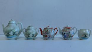 A Japanese tea set and 2 Chinese tea pots 18x18cm.