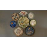 A collection of Oriental plates, a covered serving dish and an Imari plate.