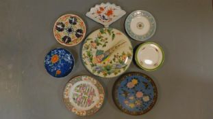 A collection of Oriental plates, a covered serving dish and an Imari plate.