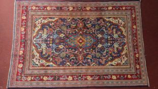 A Persian Mahal carpet, central diamond medallion with repeating floral motifs on a sapphire field