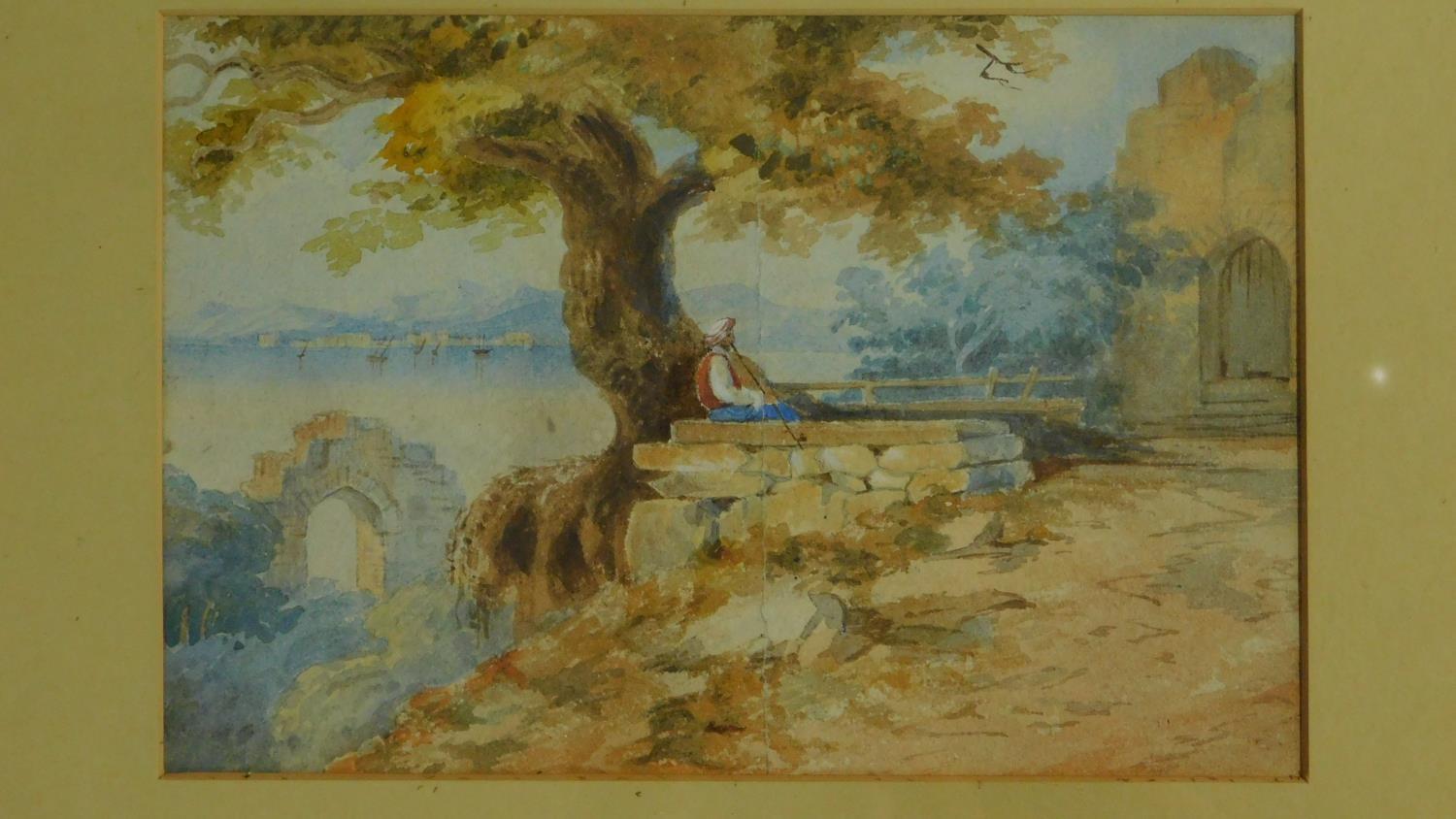 An early 20th century watercolour of a middle eastern man smoking a pipe under an olive tree, with - Image 2 of 3