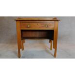 An Arts and Crafts oak desk fitted frieze drawer. H.85 W.84 D.44cm