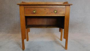 An Arts and Crafts oak desk fitted frieze drawer. H.85 W.84 D.44cm