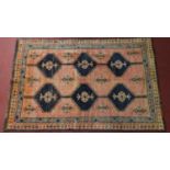 A southwest Persian Lori rug, repeating stylised geometric motifs on a madder ground guarded by a