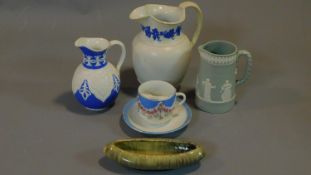 Three 19th century and later jugs, a 19th century cup and saucer and a West German pin tray.