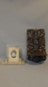 A 19th century Black Forest carved hanging shelf and an Art Deco marble photograph frame. 48x26cm