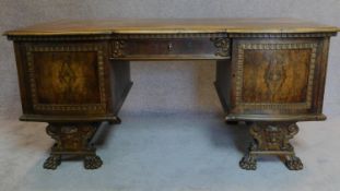 A 1930's German carved oak desk fitted drawers and cupboards. H.76 W.174 D.82cm