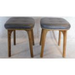A pair of vintage 1970's ash stools upholstered in buttoned charcoal leather 47x37x37