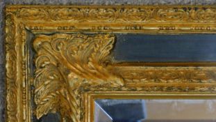 An ornate rococo style gilt framed mirror. H.78 W.67cm