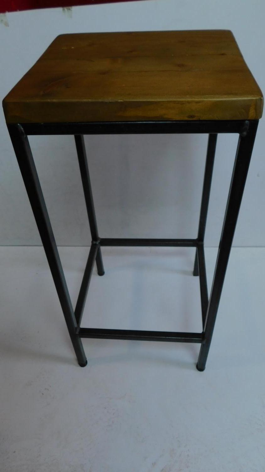 A tubular metal night table with solid teak top. 75x35cm.