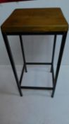 A tubular metal night table with solid teak top. 75x35cm.