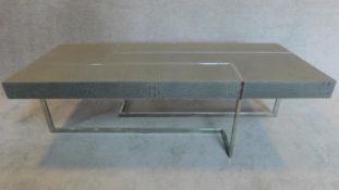 A Roche Bobois contemporary coffee table with faux grey crocodile skin cladding, raised on chrome