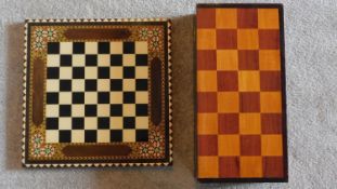 A faux ivory chess set in a fitted chess board case and another inlaid chess board. 10x46x23cm