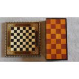 A faux ivory chess set in a fitted chess board case and another inlaid chess board. 10x46x23cm