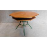 A mid 20th century teak octagonal topped two tier centre table on a green metal frame. H.70 W.92cm