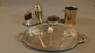 A collection of silver plated items to include a vintage cocktail shaker, wine coaster, wine