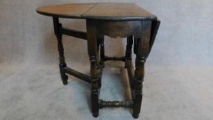 A Jacobean style Ipswich oak drop flap table on turned stretchered supports. H.73 W.120 D.91cm