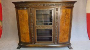 A 1930's German carved oak cabinet with burr walnut inlaid panel doors. H.185 W.233 D.40cm