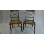 A pair of Regency ebonized and part gilt painted chairs with cane seats, the X-framed back rests