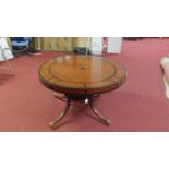 A mid 20th century Regency style walnut and part ebonized centre table, raised on 4 reeded splayed