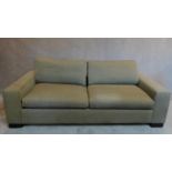 A modern 2 seater sofa in beige upholstery. H.62 W.200 D.105cm