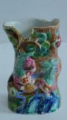 A mid 19th century Chinese brush pot decorated with foo dogs, flowers and butterflies, 11x7cm.