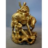 A Chinese gilt painted wooden figural carving of a man on a horse and a traveller, H.31cm