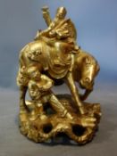 A Chinese gilt painted wooden figural carving of a man on a horse and a traveller, H.31cm