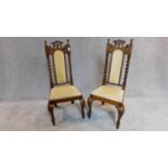 A pair of Victorian oak hall chairs, with barley twist supports and velour upholstery, raised on