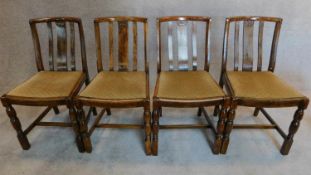 A set of four mid 20th century oak dining chairs. H.88 W.44 W.39cm