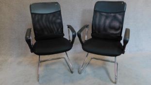 A pair of chrome tubular framed office chairs. 103x60x50cm