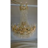 A gilt metal and crystal chandelier of basket form. All crystals present. 65x44cm.