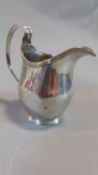 A 19th century English hallmarked silver cream jug. 6 troy ounces. 12x11cm