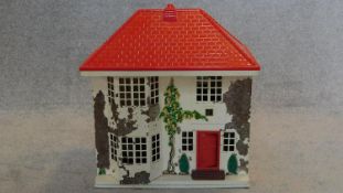 A vintage dolls house with slide across front to include some furniture. H.50 W.45 D.29cm