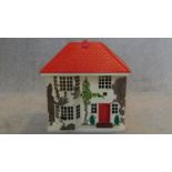 A vintage dolls house with slide across front to include some furniture. H.50 W.45 D.29cm