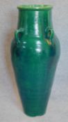 A large green glazed sharab wine vessel. H.90 W.40cm