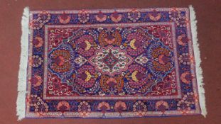 A Turkish Ushak Rug, with central medallion and repetitive symmetrical motifs set on a blue field