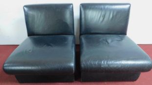 A pair of black leather easy chairs H.68 W.59 D.66