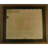 A large glazed and gilt framed indenture. signed and sealed. H.80 W.93cm
