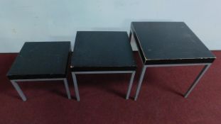 A nest of 3 modern stained oak tables on metal tubular frames. H.50 W.50 D.50