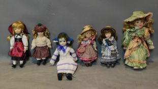 A collection of six porcelain dolls, to include by Leonardo Collection wearing a dress and bonnet,