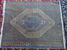 A Persian rug with central medallion within border with geometric motifs, 155 x 130cm