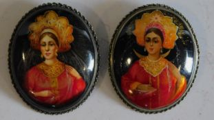 A pair of hand painted Indian brooches. 5x4cm