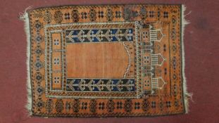 A Persian prayer rug with stylised motifs on an orange field within geometric borders, 140cm x 100cm