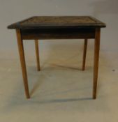 A carved top teak occasional table. H.49 W.53 D.55cm