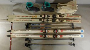 Two pair of skis, sticks and a pair of boots. 185cm